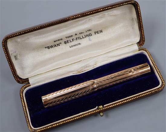 A boxed Swan 9ct gold engine-turned self-filling fountain pen.